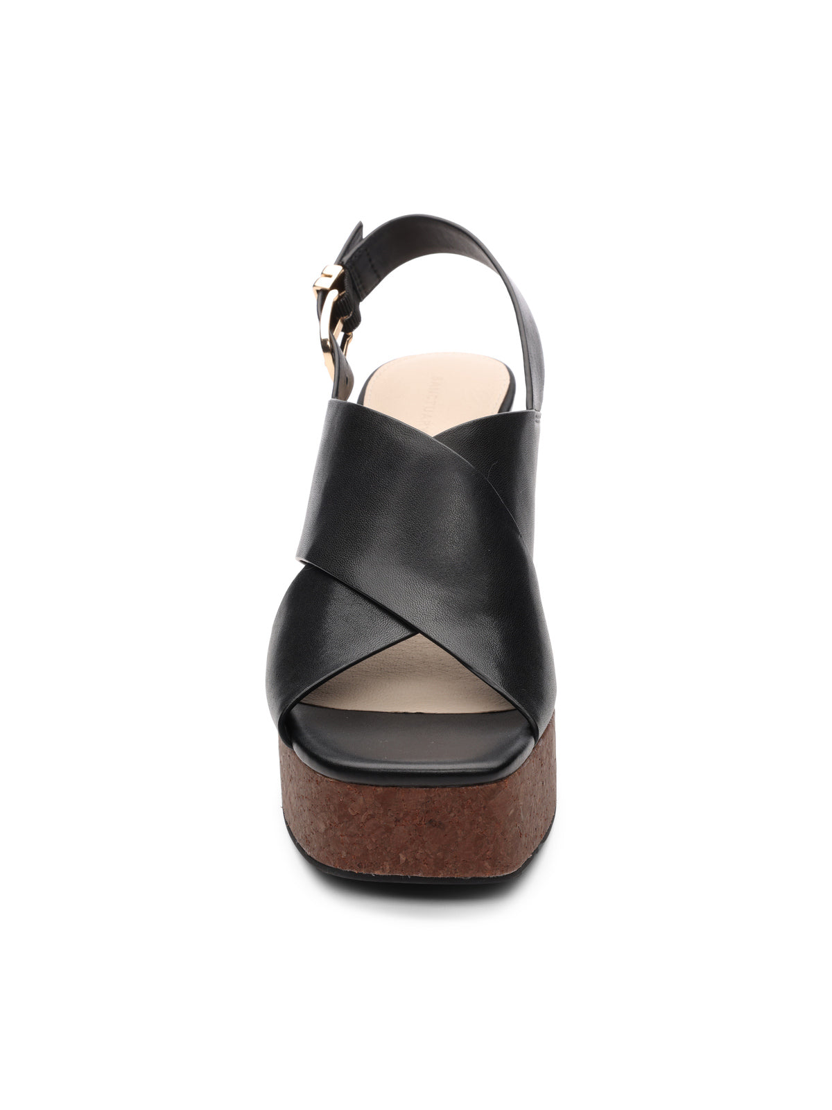 Front view of the Sanctuary Clothing nouveau black sandal featuring a wide cross-strap, adjustable ankle strap, brown cork wedge sole, and closed footbed against a white background.