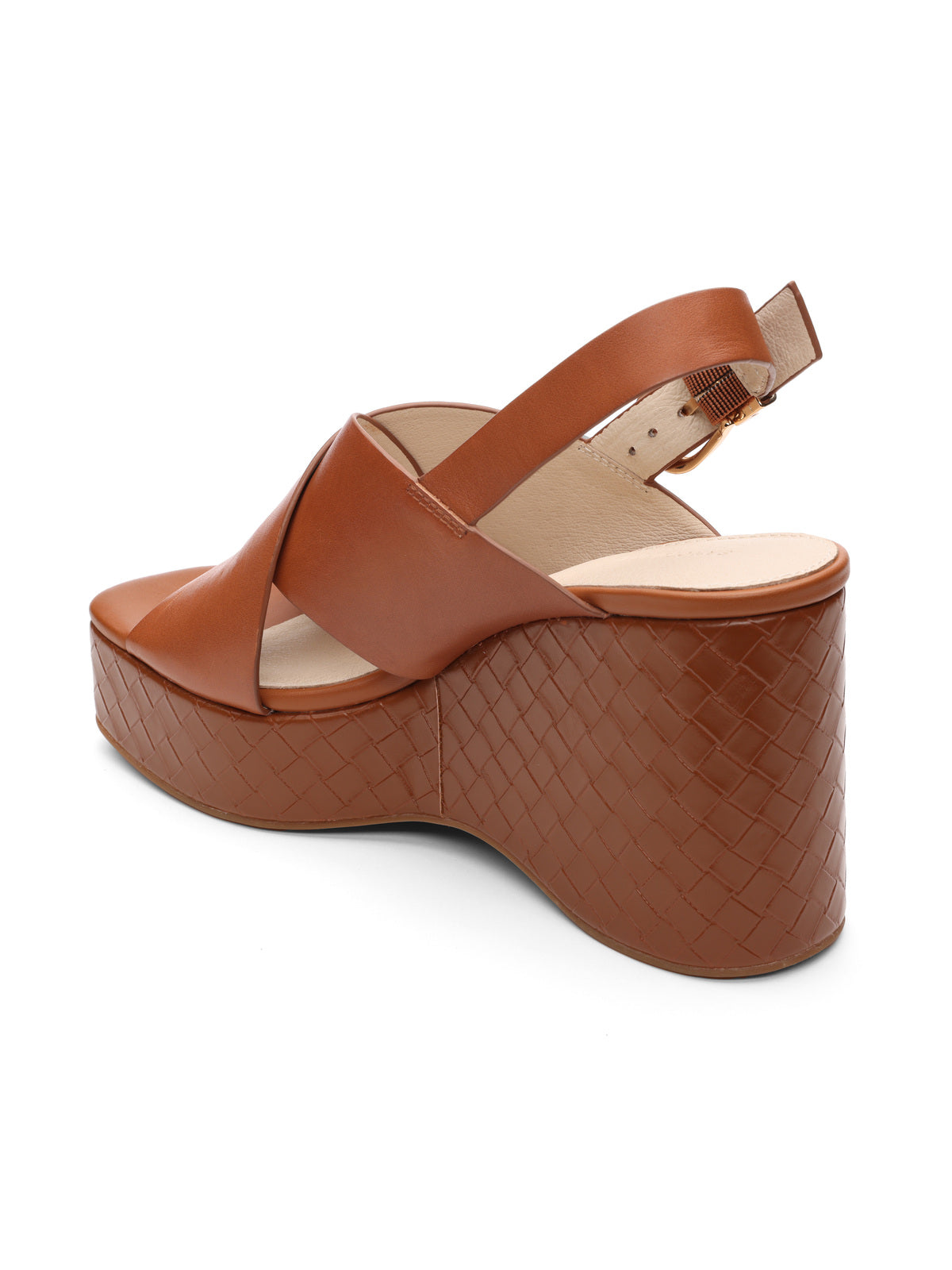 The "nouveau luggage" by Sanctuary Clothing is a brown open-toe wedge sandal featuring a woven platform heel, an ankle strap, and a leather criss-cross upper. Angled to show the back and side view.