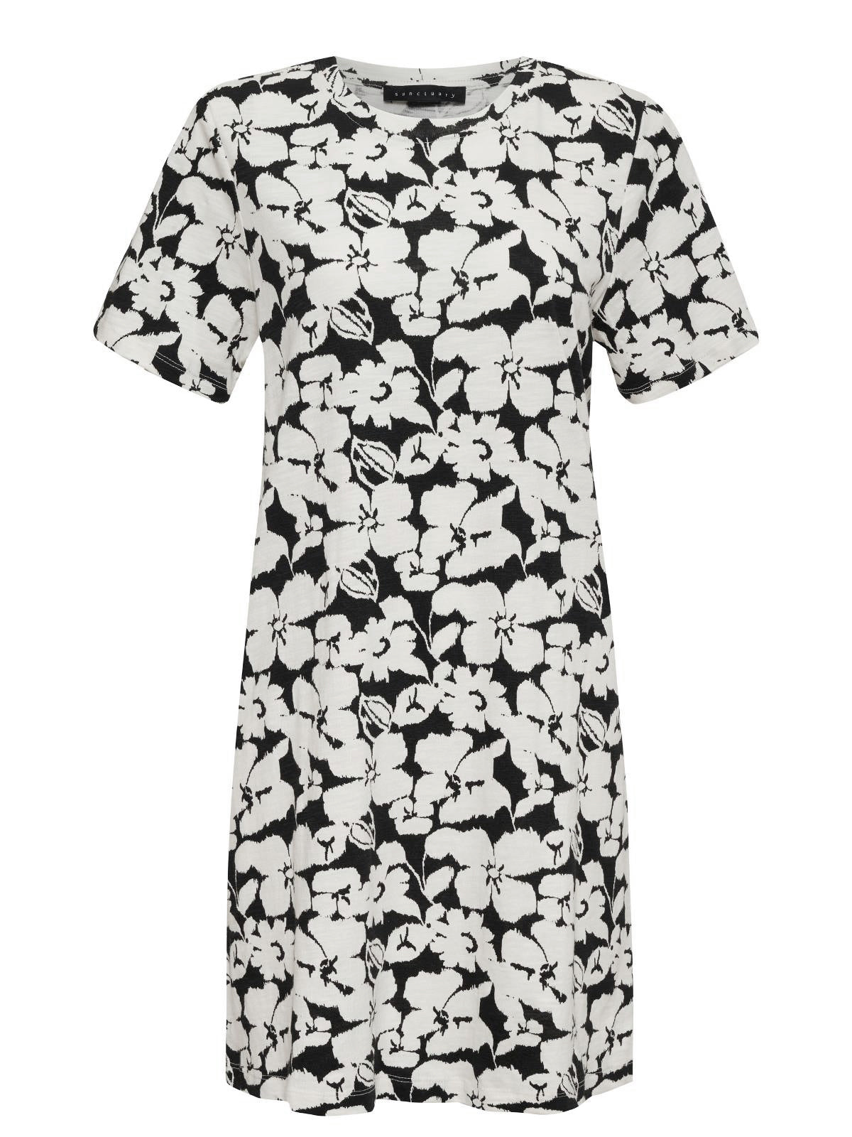 The Only One T Shirt Dress Echo Blooms from Sanctuary Clothing is a short-sleeved, knee-length dress with a black and white floral pattern. It features a round neckline and offers a straightforward, relaxed fit.