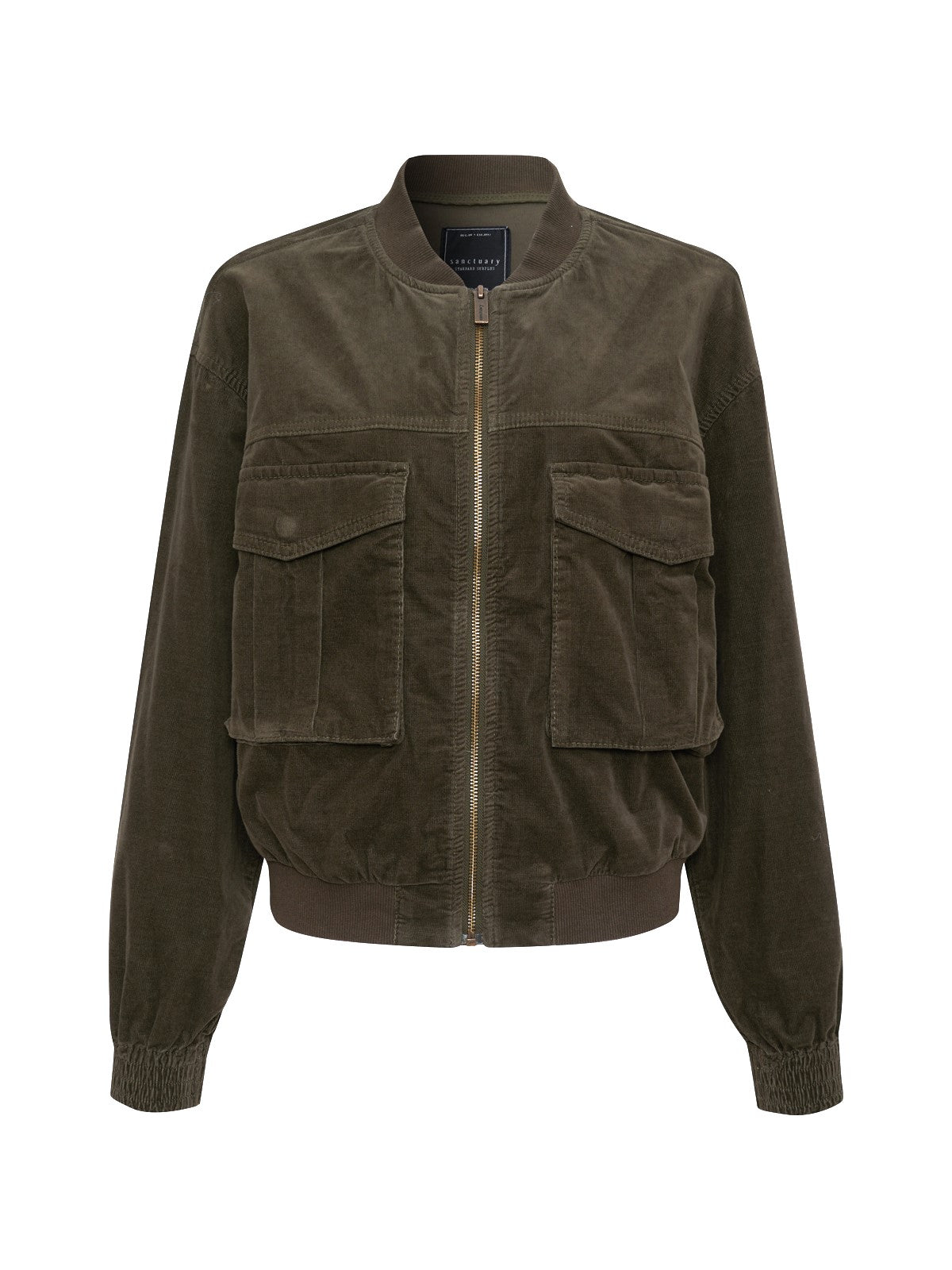 The Corduroy Surplus Bomber in Burnt Olive by Sanctuary Clothing features a front zipper and two large flap pockets on the chest. This bomber jacket boasts a ribbed collar, cuffs, and hem for a fitted look, while its corduroy material provides a rich, textured appearance.