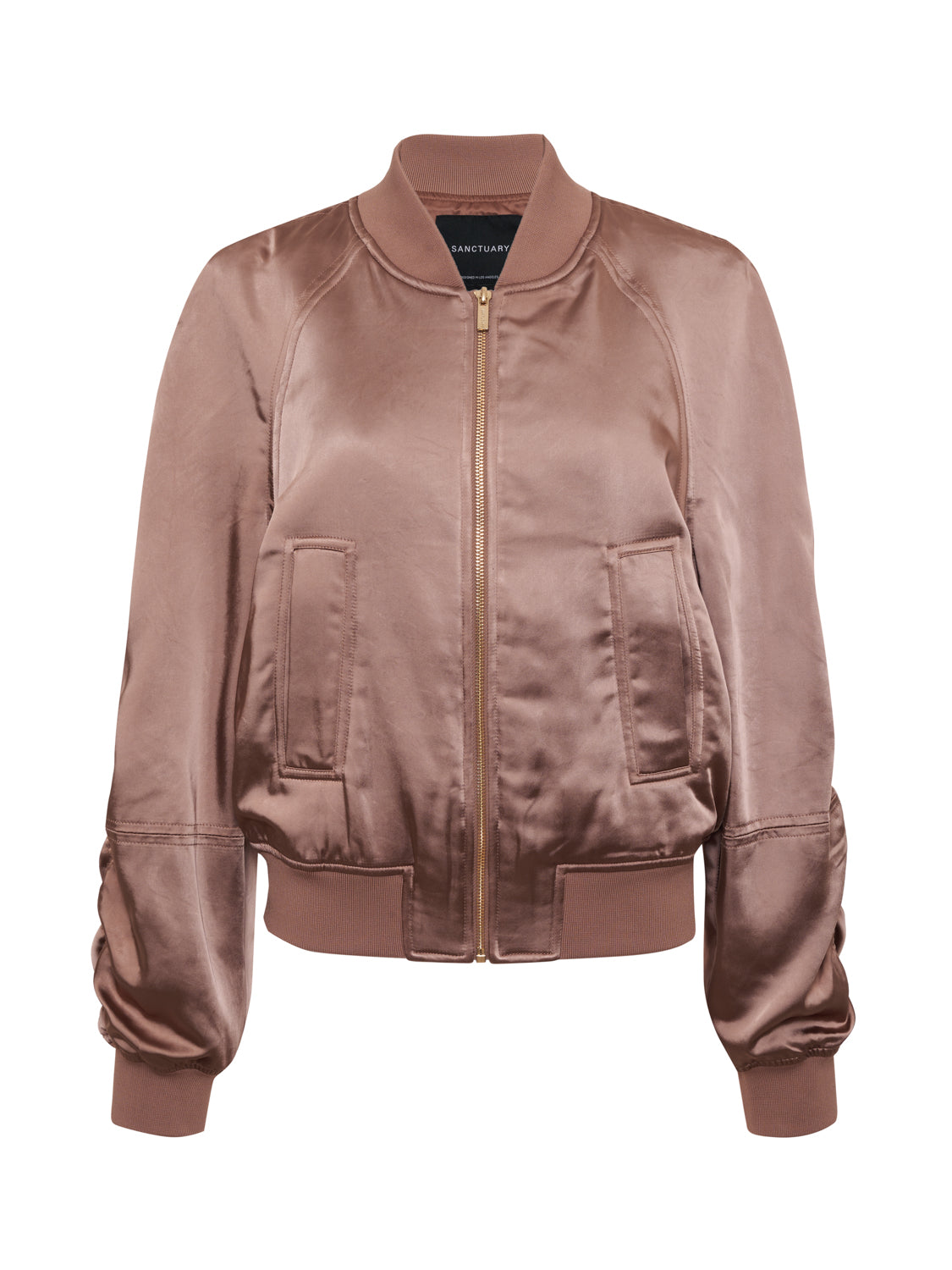 A rose gold satin ruched bomber jacket from Sanctuary Clothing featuring a front zipper, two side pockets, ribbed cuffs, and a ribbed waistband. The fabric's slight sheen adds a stylish and casual touch.