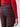 A person dressed in a red long-sleeve top is wearing the high-waisted Runway Legging in Mars Red Check by Sanctuary Clothing. The legging's striking plaid pattern and texture are prominently showcased, with their left arm visible alongside their body.