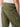 Close-up of a person wearing Sanctuary Clothing's Reissue Cargo Pant in Mossy Green. The image shows the back view, highlighting the pants' large back pockets and side pockets, along with a part of a white shirt tucked in. The person is standing against a plain background.