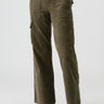 A model is showcasing the Reissue Cargo Burnt Olive pants from Sanctuary Clothing, featuring a high-waisted design and large thigh pockets. The model pairs these olive green cargo pants with black ankle boots and a light-colored top that is partially tucked in. The background is plain white, highlighting the outfit.