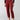 A person stands against a plain background wearing the Classy Cargo Trouser Garnet by Sanctuary Clothing, paired with a matching belt. They are also wearing a black long-sleeved top and black flat shoes with buckles. The photo is cropped to show only the body from the shoulders down.