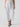 A person is modeling the Sanctuary Clothing Reissue 90S Sash White wide-legged, cropped pants with a fabric belt tied at the waist and large front pockets. They are wearing black open-toe heeled sandals with gold accents. The background is plain white.