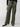 A person is wearing the "Satin Cargo Wide Leg Dark Olive" pants by Sanctuary Clothing, which feature multiple pockets and a drawstring waist. They have paired this outfit with black ballet flats and a black top. The background is plain and gray, and their left hand rests by their side.