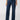 A person is shown from the waist down wearing the Marine Full Length Aspen jeans from Sanctuary Clothing, featuring a dark blue high-waisted design with a wide-leg cut. They pair these with black pointed-toe shoes and a dark top, set against a simple light gray background.