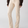 A person is wearing the Sanctuary Clothing Corduroy Hayden Bootcut pants in Toasted Almond, featuring a high-waisted fit, front pockets, and seam detailing. The person has tucked a dark brown sweater into the pants and is wearing beige ankle boots with a small heel. The background is plain white.