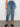 A person is wearing the "sculpted hayden straight crop best in show" jeans by Sanctuary Clothing, paired with black shoes, standing against a plain background. Only the lower half of their body is visible.