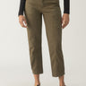 A person is standing in the Sahara Tapered Pant in Burnt Olive by Sanctuary Clothing, alongside a black long-sleeve top. These pants feature multiple pockets, and the individual complements their look with black flat shoes featuring ankle straps.