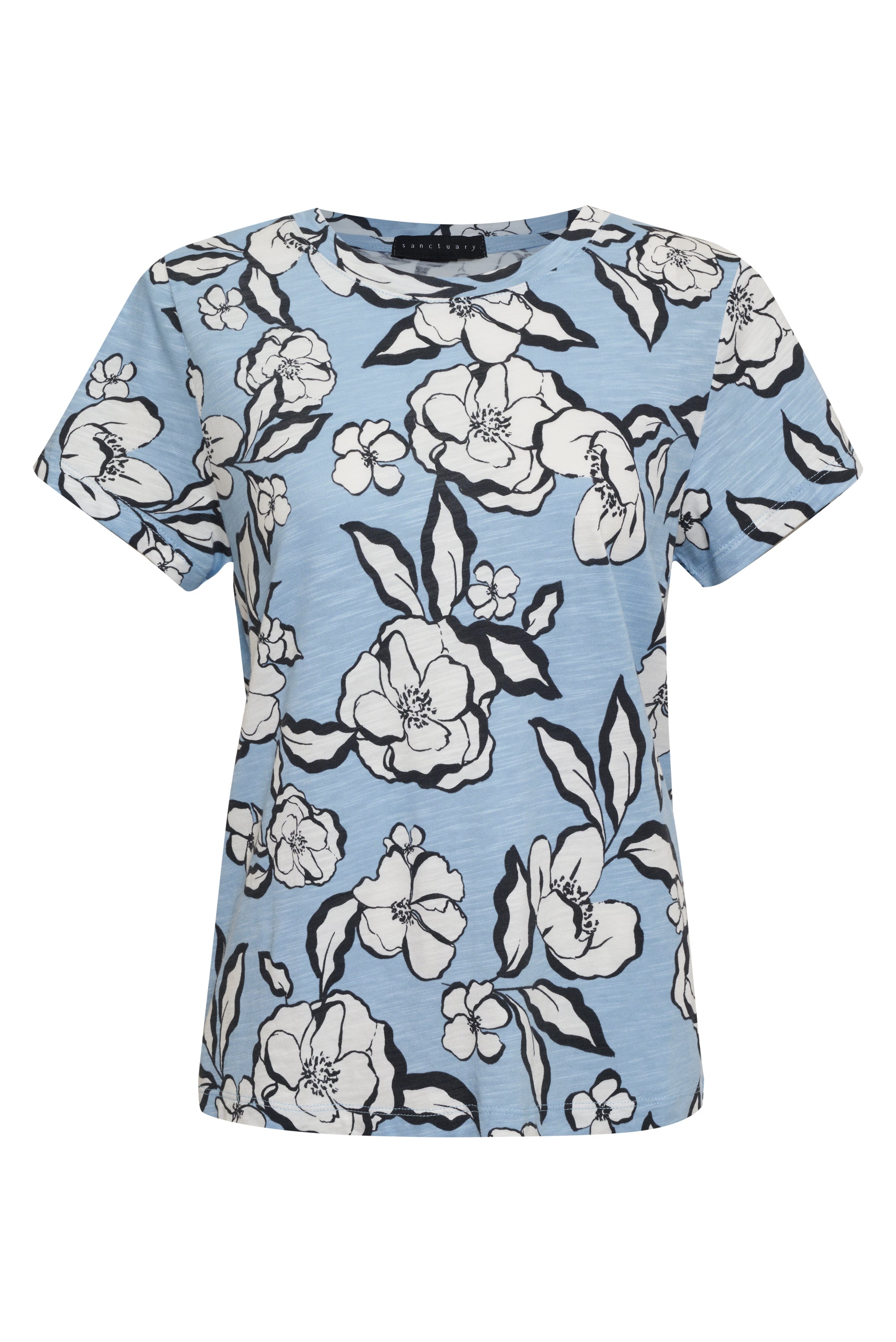 A light blue short-sleeved blouse from Sanctuary Clothing, named The Perfect Tee Blue Bliss Floral, features a bold white and black floral print. Large flowers are spread evenly across the fabric, creating a visually striking pattern. The blouse also has a simple, round neckline.