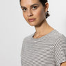 A person with dark hair tied back wears the perfect tee pumice stone black stripe by Sanctuary Clothing, looking directly at the camera against a plain light-colored background.