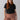 A woman with long red hair is standing against a plain background. She is wearing the Perfect Mesh Tee Black from the Inclusive Collection by Sanctuary Clothing and brown cargo pants. Her expression is neutral, and her hands are relaxed by her sides.