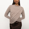 Someone is wearing a Long Sleeve Mock Draped Top in Heather Cocoa by Sanctuary Clothing paired with a dark brown skirt. The background is plain white.