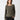 A person with long, brown hair is wearing the Everyday Openwork Sweater Kalamata by Sanctuary Clothing paired with black pants. With one hand in their pocket, they look confidently at the camera against a plain white background.