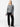 A person stands against a plain white background, wearing the Uptown Girl Sweater in Heather Ash by Sanctuary Clothing along with black trousers. Their hands are at their sides, and they are wearing black shoes. They have long, light-colored hair and a neutral expression.