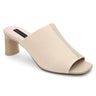 The Behold Sandal Milk Birch by Sanctuary Clothing is a beige open-toe mule featuring a block heel and a textured fabric upper. It has a moderately high heel and exudes a minimalist design. The interior sole is crafted in a lighter shade, offering an elegant contrast to the textured exterior.