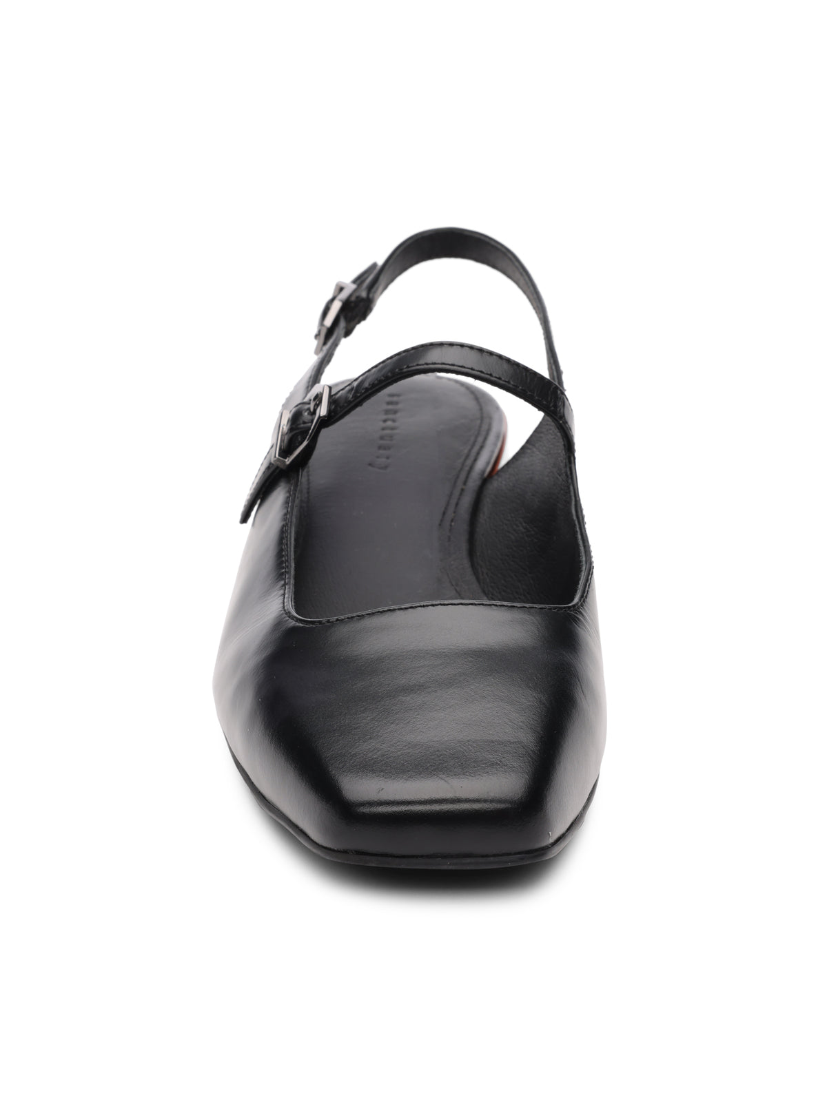 The Everly Slingback Flat Black shoe by Sanctuary Clothing, featuring a black leather finish, square toe design, and two thin ankle straps with silver buckles, is displayed against a plain white background.