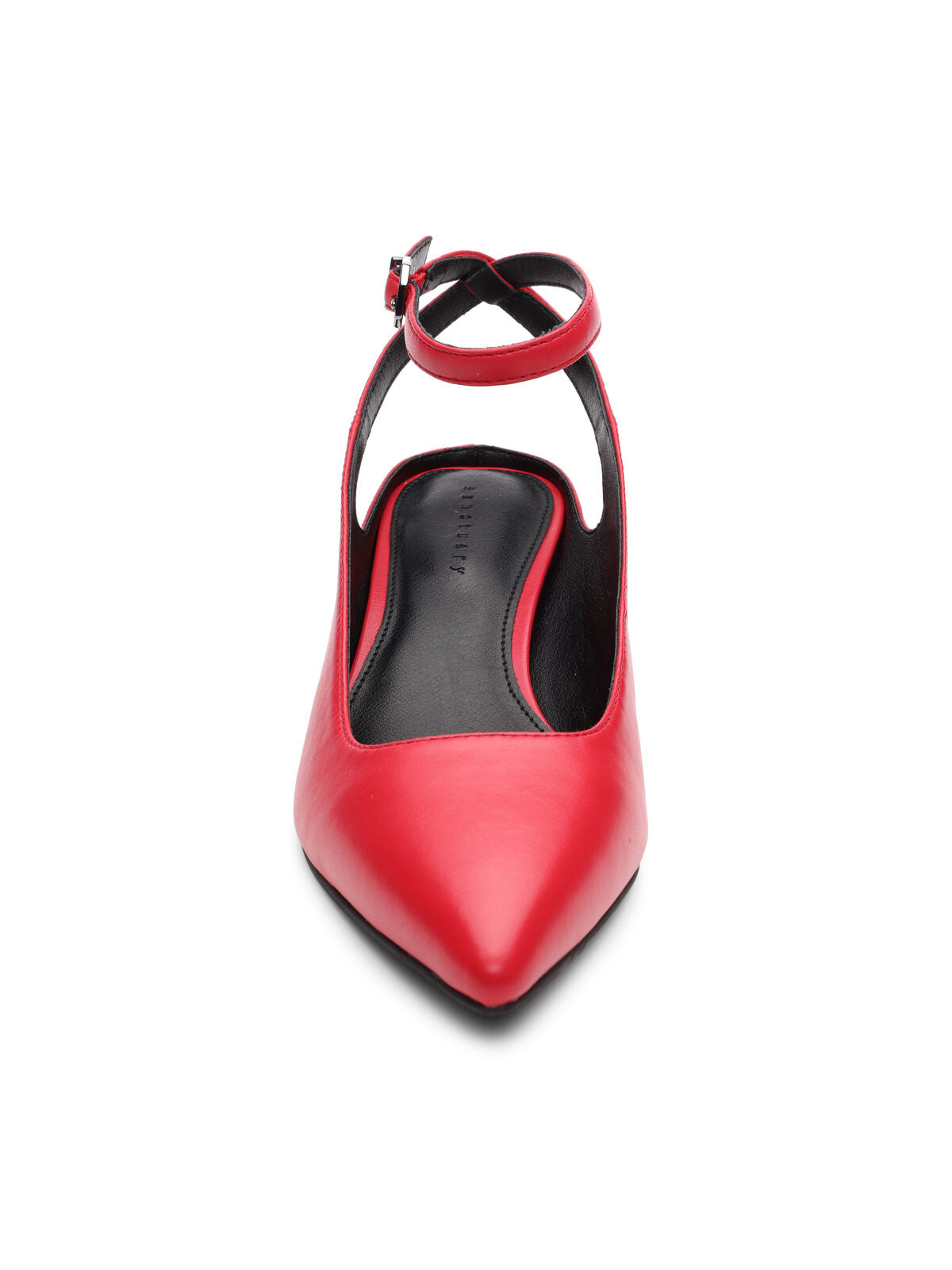 Front view of the Magic Pump Red by Sanctuary Clothing, showcasing a single red high-heeled shoe with a pointed toe and a thin ankle strap featuring a small buckle. The shoe boasts a sleek and elegant design, with black interior lining and a slightly arched shape.