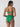 A woman in a beach goddess excess shirr waist bikini bottom by Sanctuary Clothing stands with her back to the camera. She has long dark hair and is wearing hoop earrings. The green bikini features a high-waisted bottom and a simple top with adjustable straps. The background is plain and light-colored.