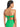 A woman with dark, wet hair is shown from the back, wearing the Refresh Rib Bandeau Bikini Top in Green Flare by Sanctuary Clothing. The strapless bikini top features a bow at the back and is paired with a high-waisted bottom, both showcasing a ribbed texture.