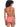 A woman with curly hair wearing the Sandbar Solids Underwire Bikini Top in Watermelon Sugar by Sanctuary Clothing. Seen from the back, the bikini top features adjustable straps and a hook closure, paired with classic cut bottoms. She stands against a white background.