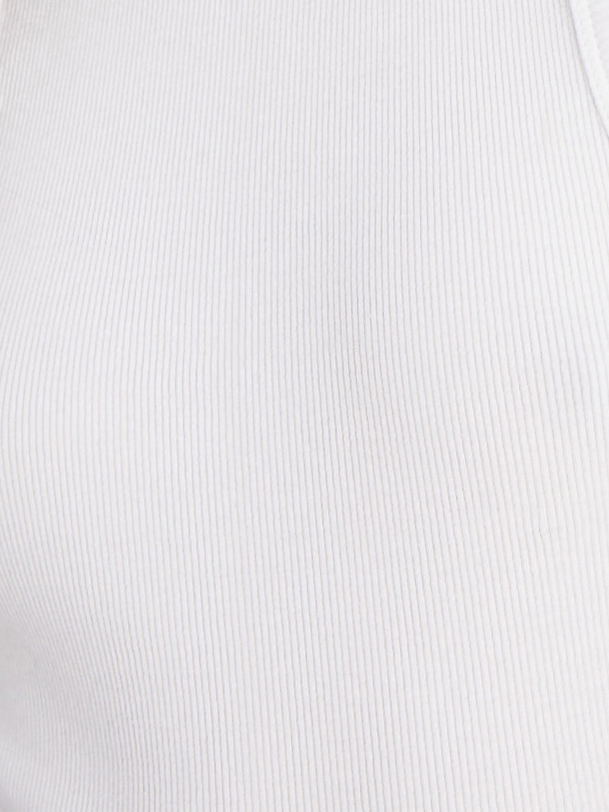 Close-up of a person wearing the Ribbed Tank Top White by Sanctuary Clothing. The fabric texture is distinctly visible, showcasing its vertical rib patterns. The image focuses exclusively on the clothing, without any additional context or background elements.