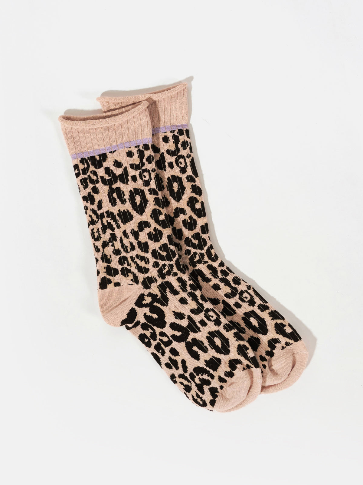 A pair of Classy Cat Socks from Sanctuary Clothing, featuring a beige color with a black and brown leopard print pattern, lying flat on a white background. The socks are designed with a ribbed cuff.